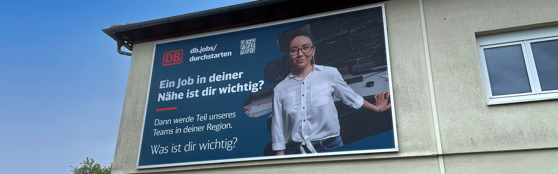 Kederrahmen+ zur Befestigung einer Fassadenwerbung an einem Gebäude des Hauptbahnhofes in Neustadt an der Weinstraße in der Detailansicht.